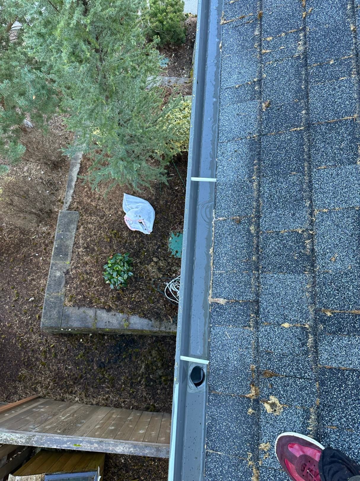 a roof gutter that has been flushed for proper drainage.
