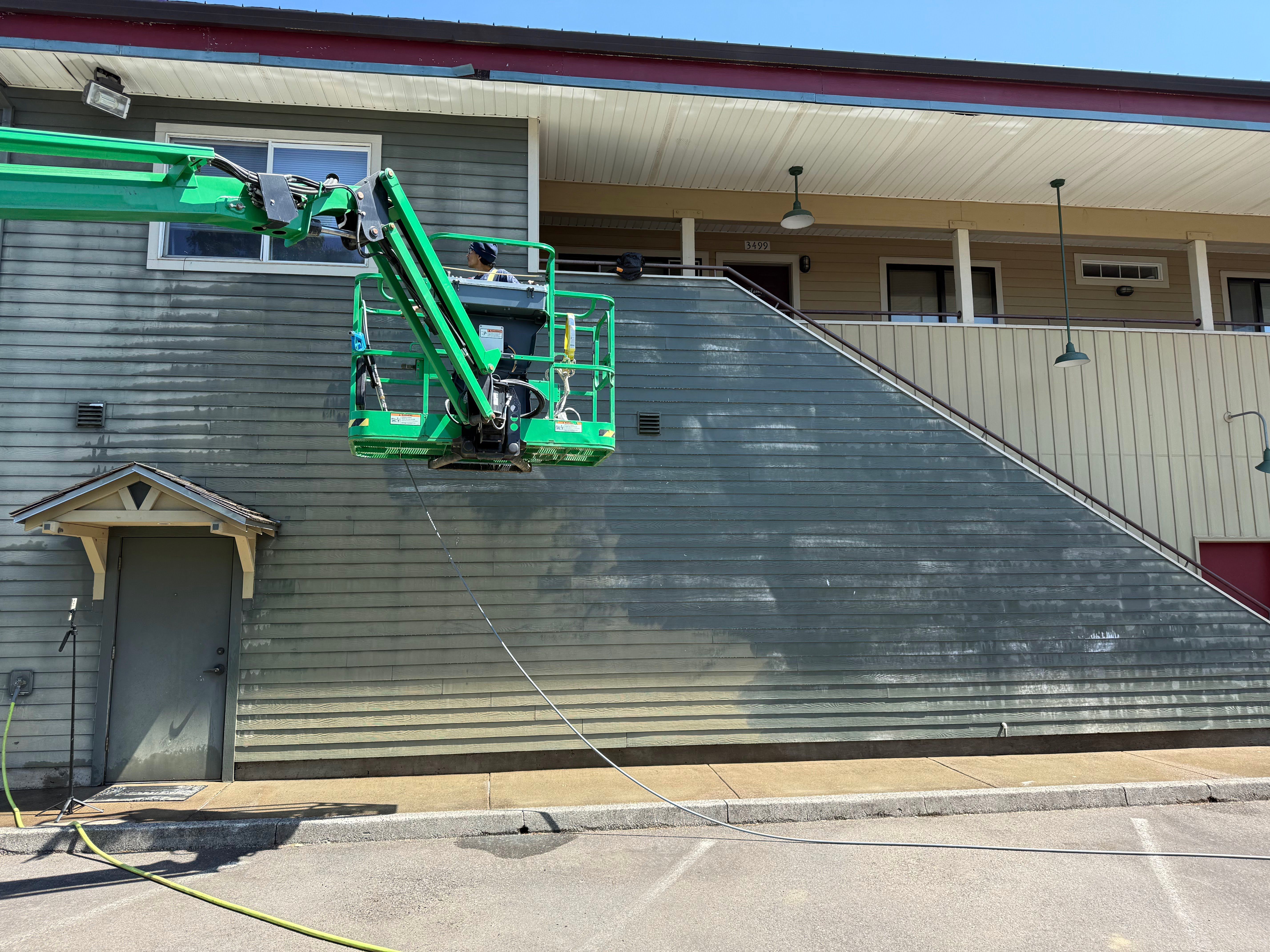 pressure washing services performed on the siding of a commercial building