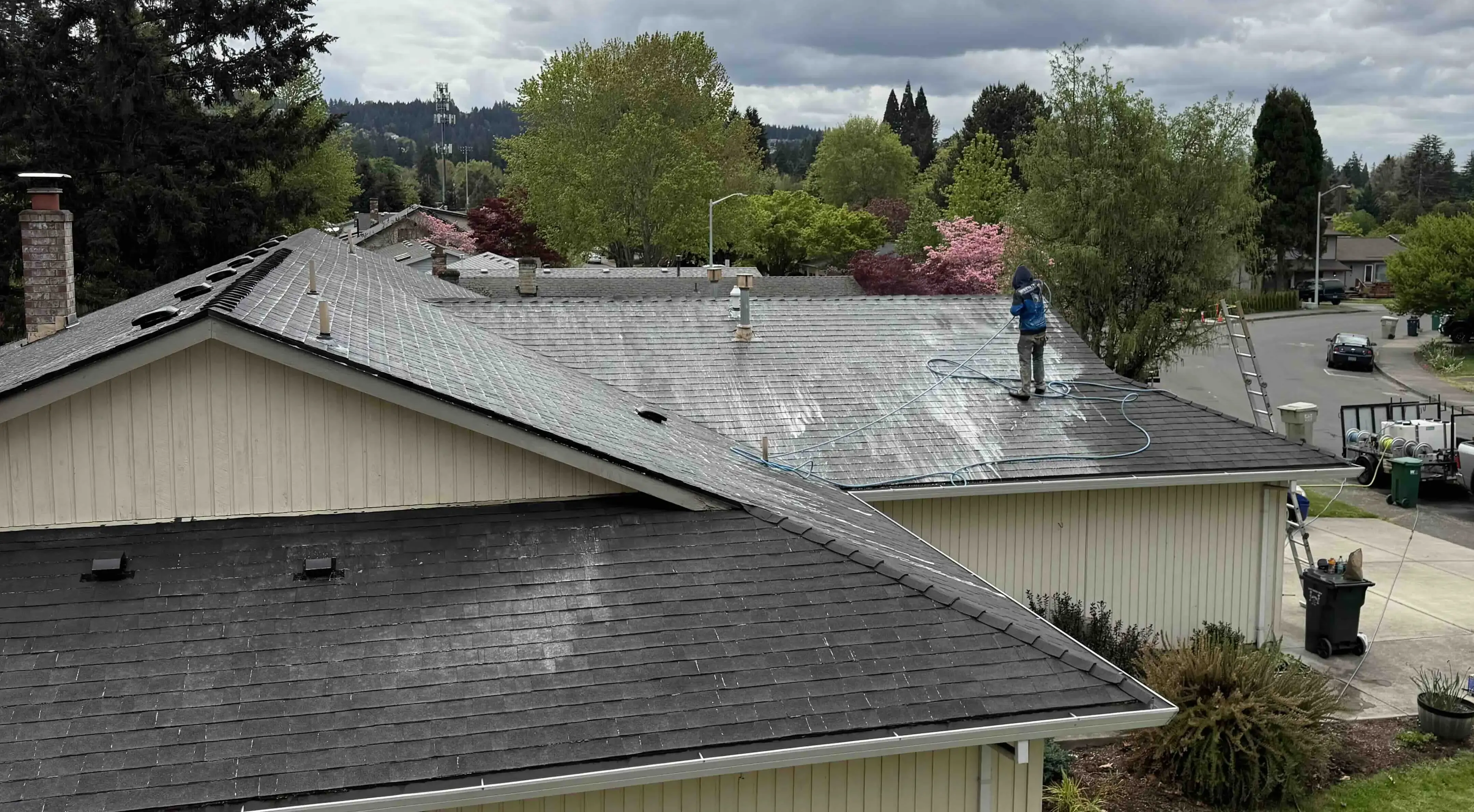 man washing a roof